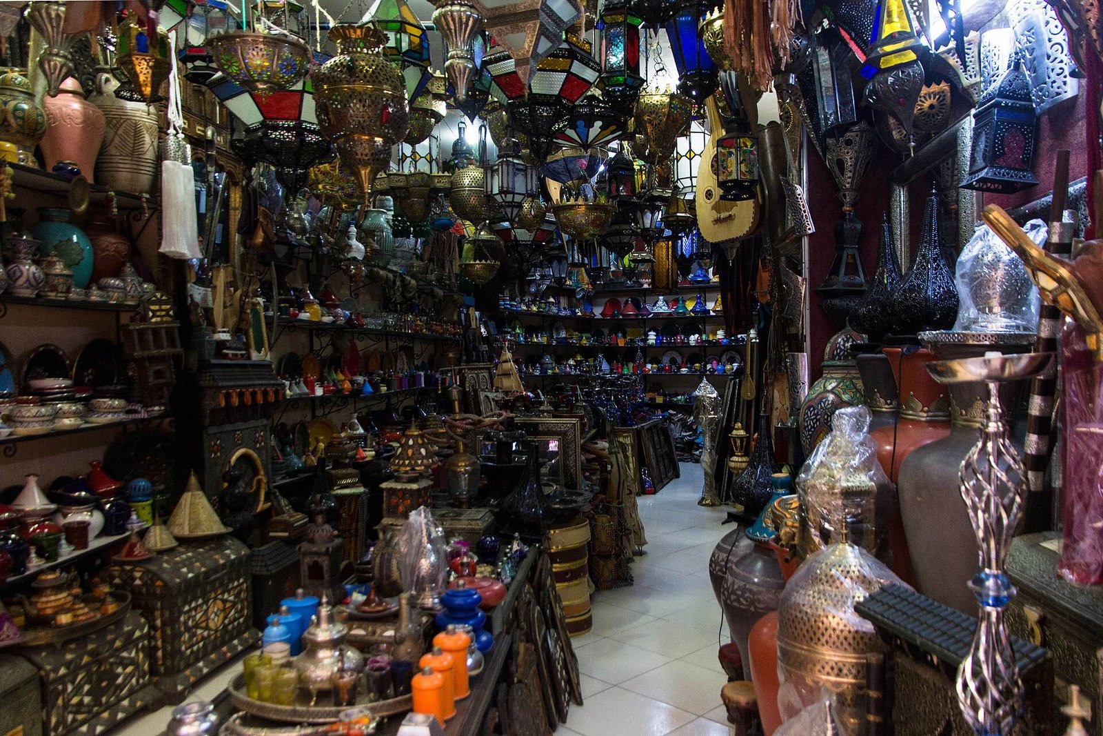Lanterns, ceramics and metalwork crowding a shop in the medina of Tangier