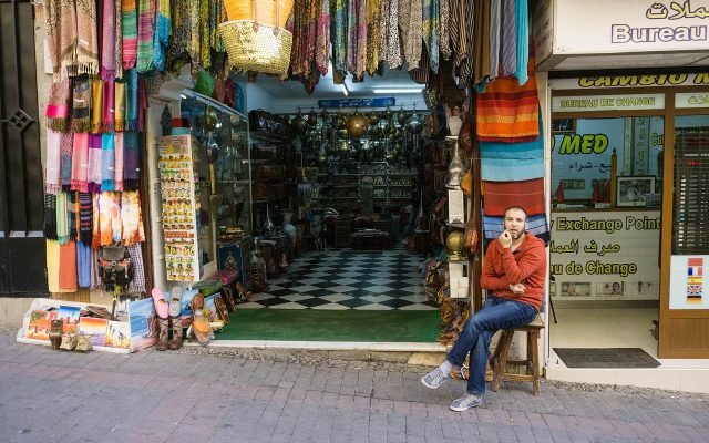 A souk shop hung with colourful scarves in Tangier’s medina