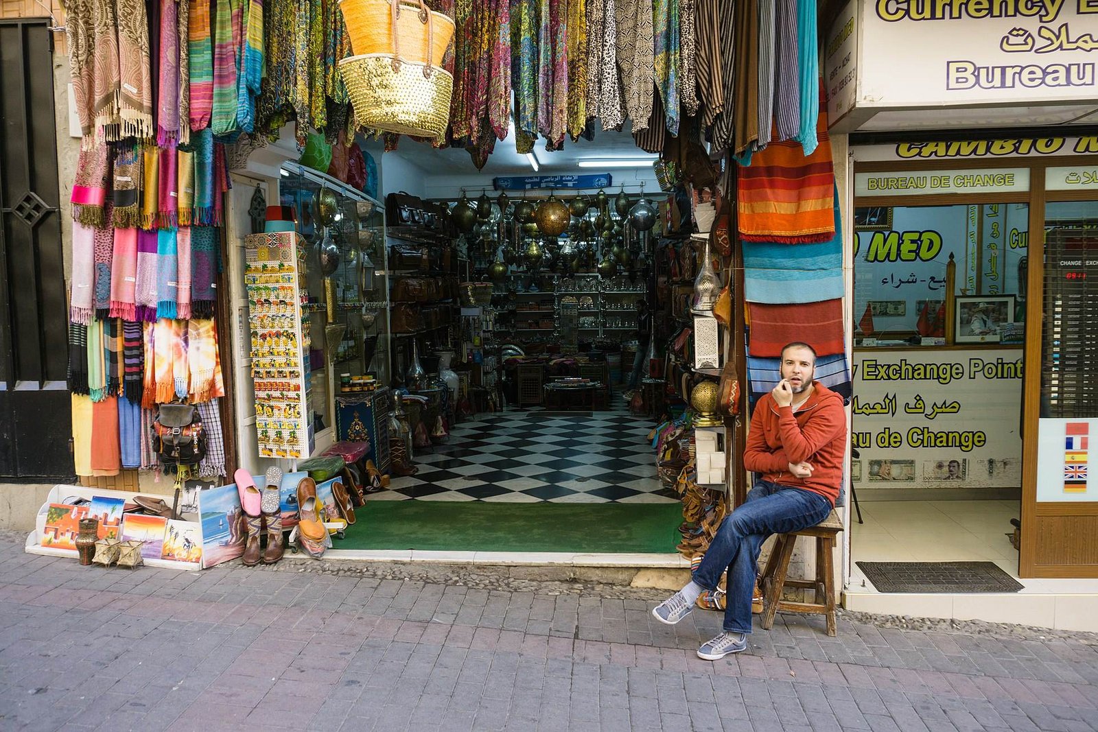A souk shop hung with colourful scarves in Tangier’s medina