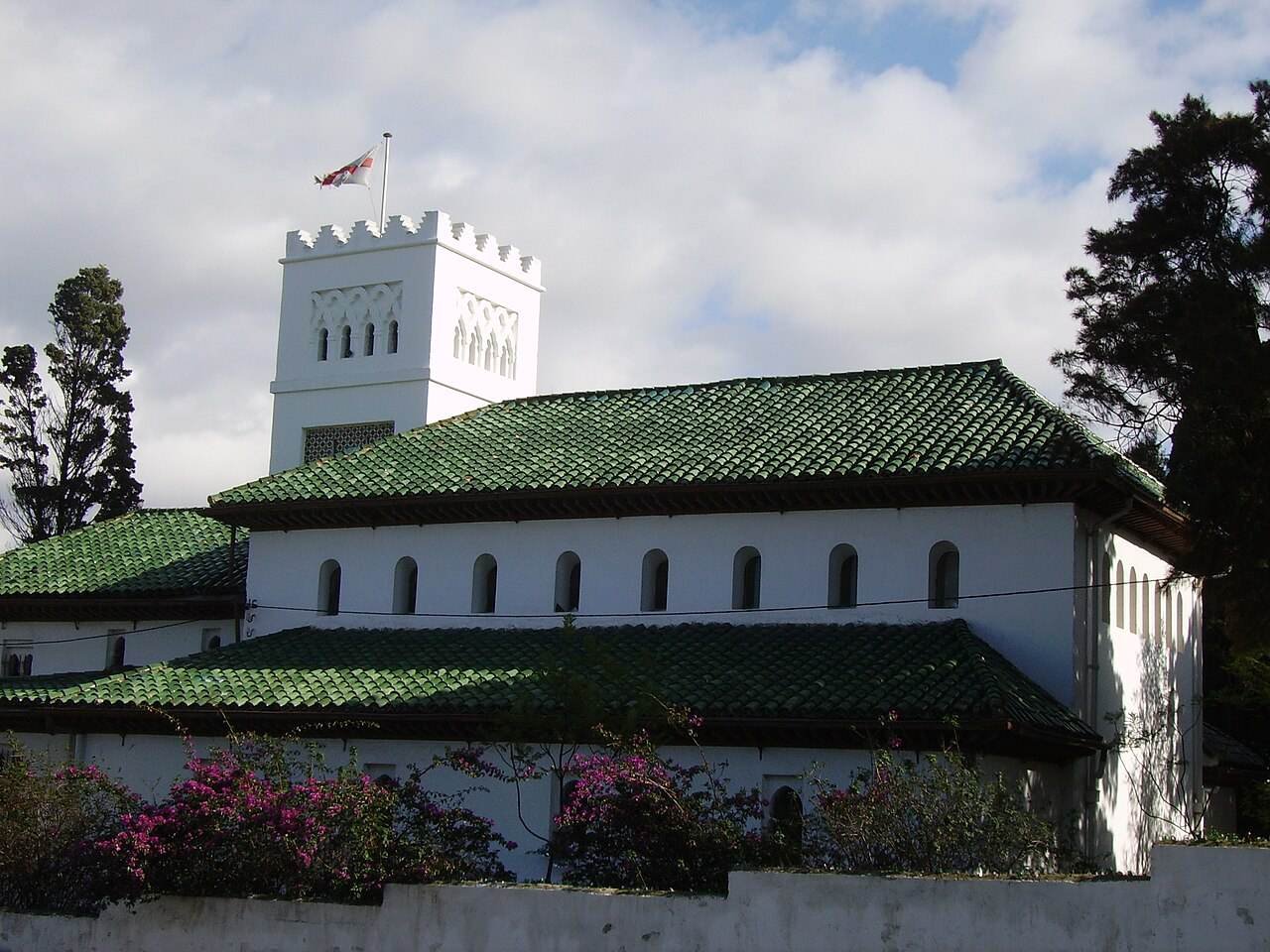 The white tower and green tiled roofs of St Andrew’s Church