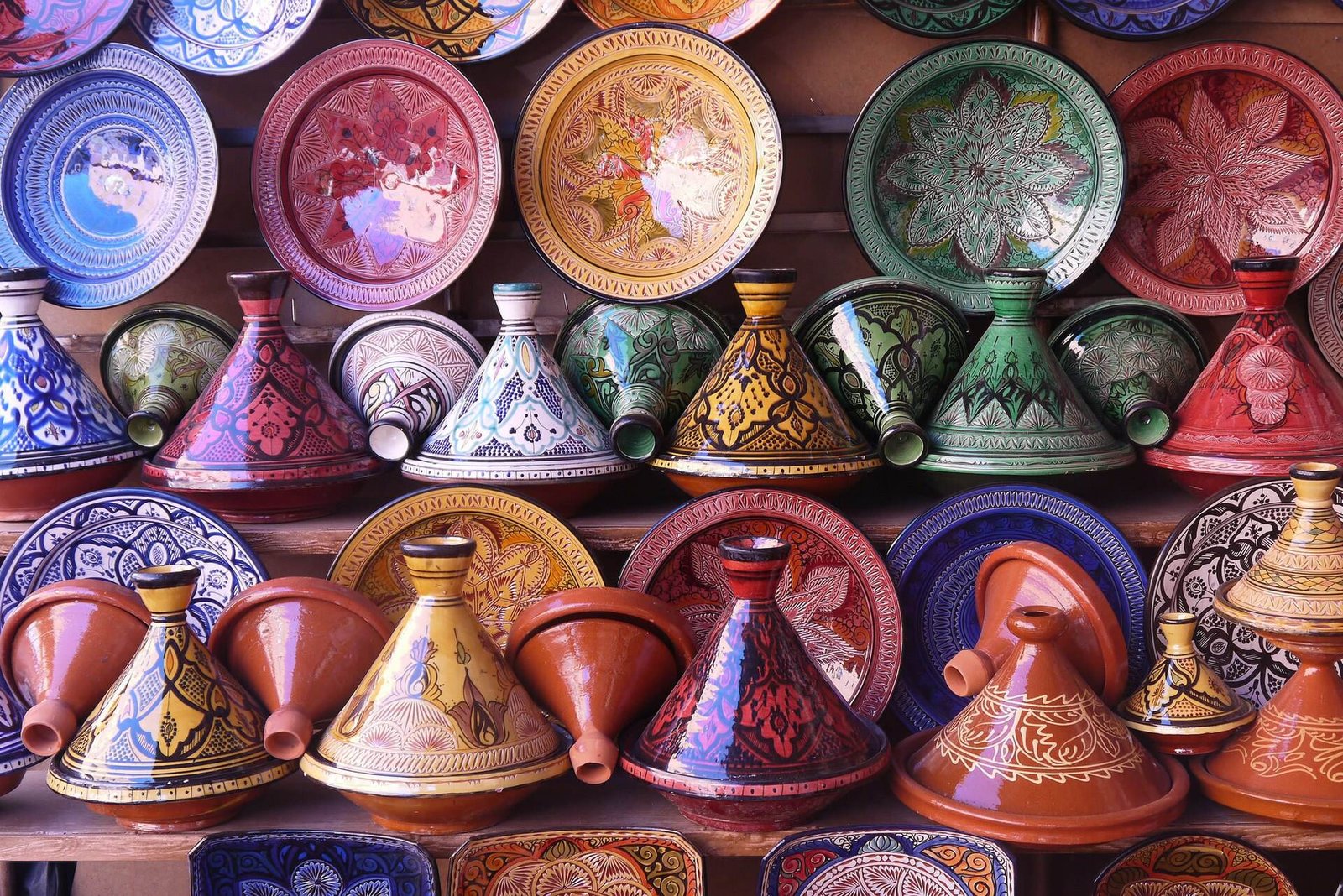 Colourful painted tagine pots stacked in a pottery shop