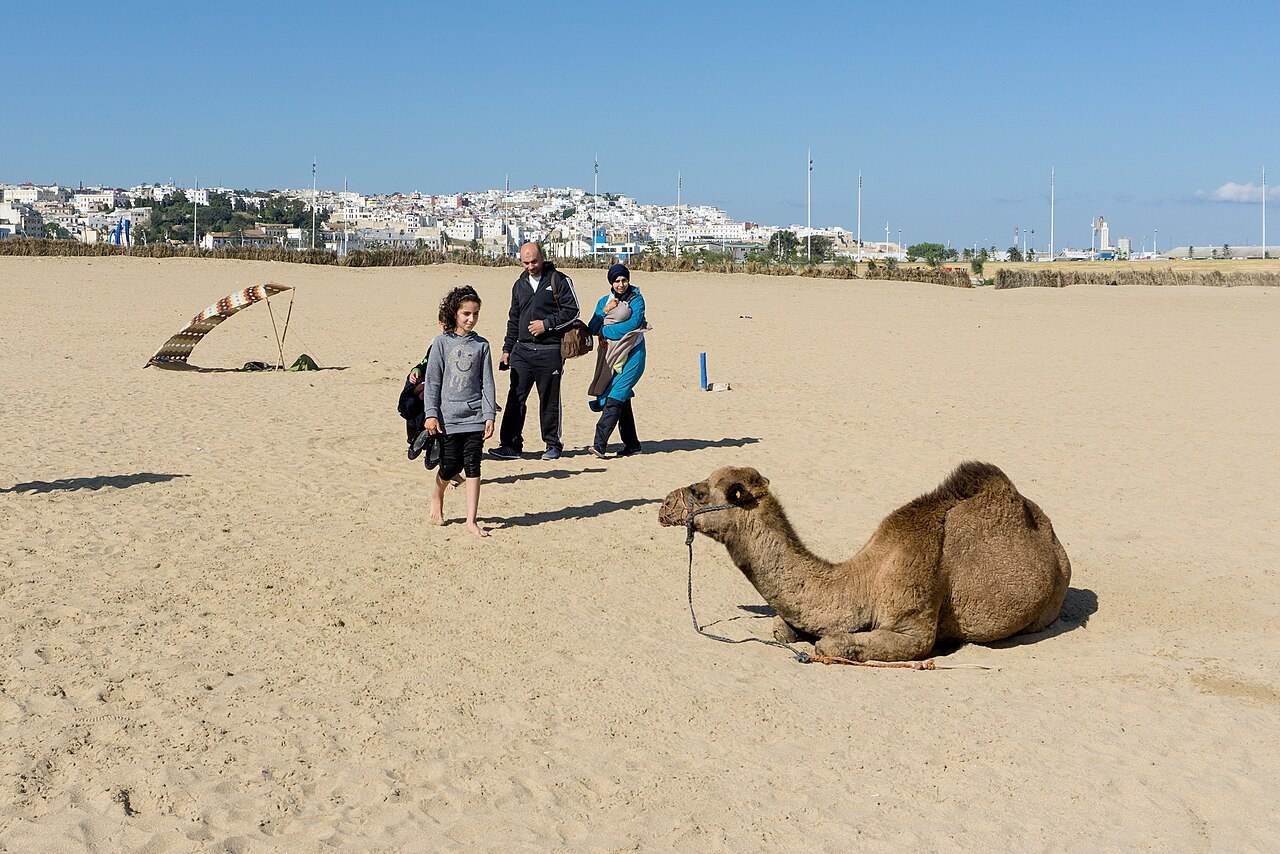 The wide sandy beach of Tangier Bay with the city behind