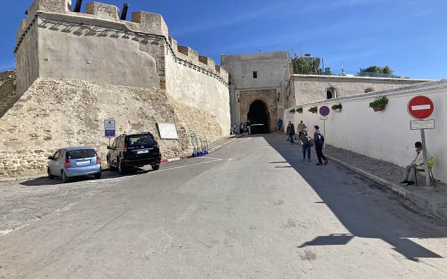Bab Kasbah gate and the walls of the Kasbah under a blue sky
