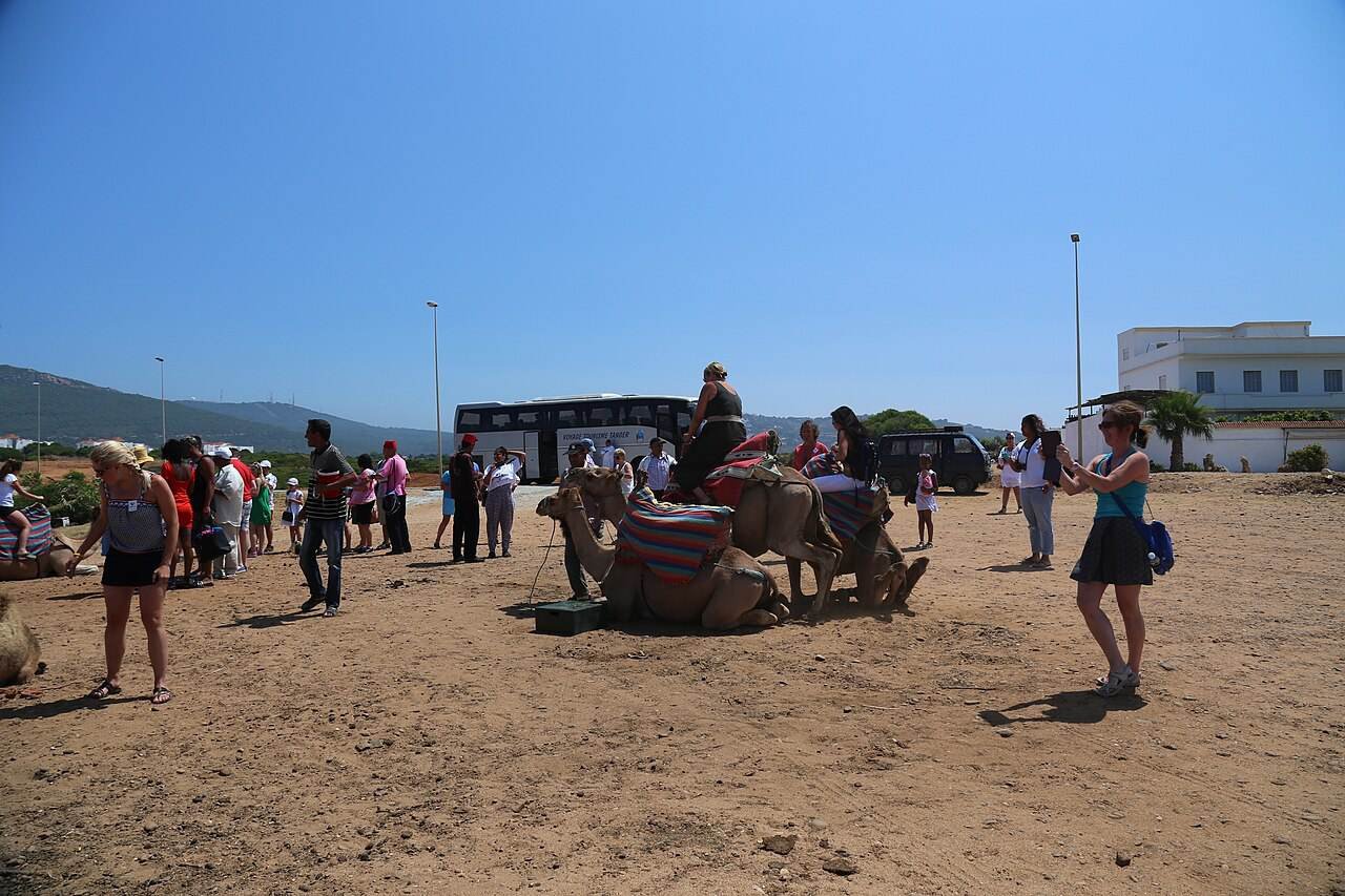 Visitors and camels on the beach at Achakkar near Tangier