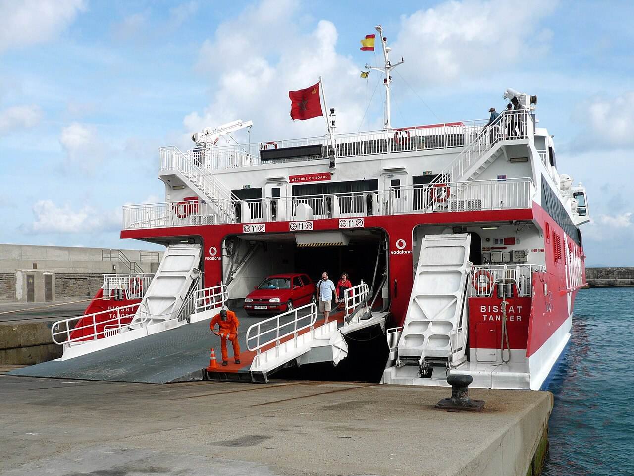 A fast ferry in port with its car ramp lowered