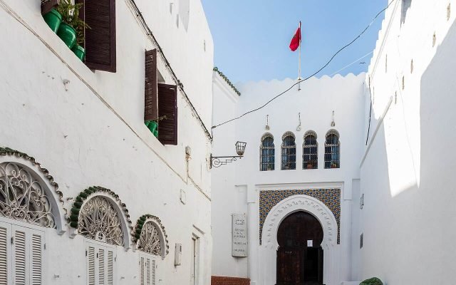 A narrow whitewashed lane in Tangier’s Kasbah leading to an arched doorway