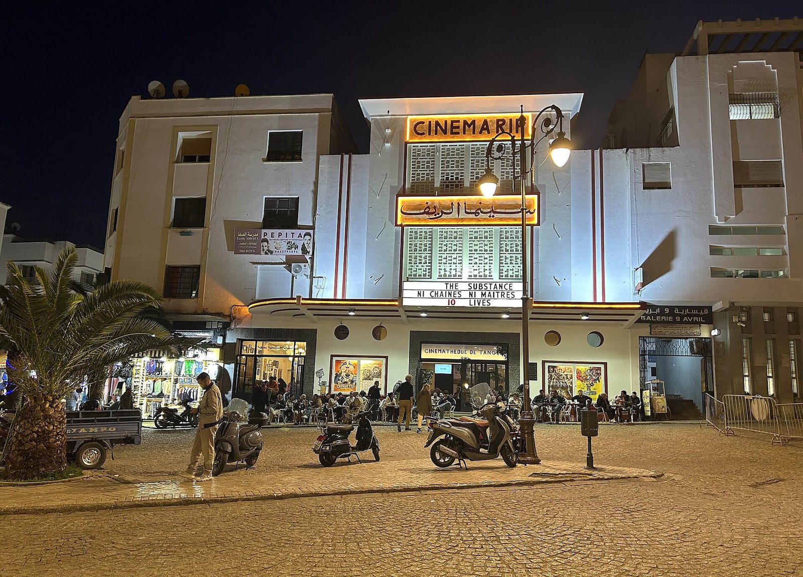 The lit-up Cinema Rif and the Grand Socco at night
